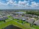 This aerial view displays the single-Gathering home's backyard and close proximity to a large community lake at 12931 Twin Bridges Dr, Riverview, FL 33579