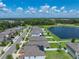 This aerial view shows the single-Gathering home with a lake view and easy access to nearby neighborhood streets at 12931 Twin Bridges Dr, Riverview, FL 33579