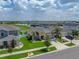 Overhead view of a home with a well-manicured lawn, beautiful landscaping, and two-car garage at 12931 Twin Bridges Dr, Riverview, FL 33579