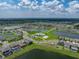 Community aerial view showcasing ponds, homes, a community center, and lush green spaces at 12931 Twin Bridges Dr, Riverview, FL 33579