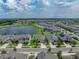 Aerial view of the single-Gathering home showcases its proximity to a lake and neighborhood amenities at 12931 Twin Bridges Dr, Riverview, FL 33579