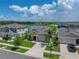 Aerial view of a beautiful home with a well-manicured lawn, two-car garage, and nearby lake at 12931 Twin Bridges Dr, Riverview, FL 33579