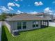 Backyard with green grass, white fence, and patio with screened enclosure at 12931 Twin Bridges Dr, Riverview, FL 33579