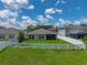 Backyard featuring a well-manicured lawn and a white picket fence for privacy at 12931 Twin Bridges Dr, Riverview, FL 33579