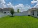 The verdant backyard is enclosed by a crisp white fence, creating a private outdoor space at 12931 Twin Bridges Dr, Riverview, FL 33579