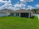 A lush green backyard boasts a pristine lawn, and a serene outdoor living space at 12931 Twin Bridges Dr, Riverview, FL 33579