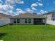 Backyard featuring a well-manicured lawn and a white picket fence for privacy at 12931 Twin Bridges Dr, Riverview, FL 33579