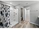 Bright bathroom with a stand-up shower and decorative curtain, plus a view into the walk-in closet at 12931 Twin Bridges Dr, Riverview, FL 33579