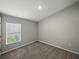 This bedroom features cozy carpet and natural light from the window at 12931 Twin Bridges Dr, Riverview, FL 33579