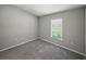 Bright bedroom with soft carpet and a large window for natural light at 12931 Twin Bridges Dr, Riverview, FL 33579