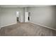 Spacious bedroom with carpet flooring and multiple doorways leading to other rooms at 12931 Twin Bridges Dr, Riverview, FL 33579