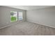 A simple bedroom with neutral carpet, two large windows, and neutral-colored walls at 12931 Twin Bridges Dr, Riverview, FL 33579
