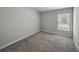 Cozy bedroom featuring neutral walls, carpet, and a bright window at 12931 Twin Bridges Dr, Riverview, FL 33579