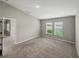Neutral bedroom with carpet, two windows, and a doorway leading to another room at 12931 Twin Bridges Dr, Riverview, FL 33579