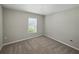 Cozy bedroom with neutral walls, plush carpeting, and a bright window at 12931 Twin Bridges Dr, Riverview, FL 33579