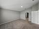 Neutral bedroom featuring plush carpeting, light gray walls, and ample natural light at 12931 Twin Bridges Dr, Riverview, FL 33579