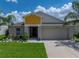Charming single-Gathering home features a manicured lawn, well-maintained landscaping, and an attached two-car garage at 12931 Twin Bridges Dr, Riverview, FL 33579