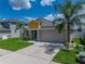 Charming single-Gathering home with a well-manicured lawn, lovely landscaping, and a two-car garage at 12931 Twin Bridges Dr, Riverview, FL 33579