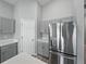 Modern kitchen featuring gray cabinets and stainless steel refrigerator with water dispenser at 12931 Twin Bridges Dr, Riverview, FL 33579