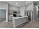 Modern kitchen with gray cabinets, stainless steel appliances, and center island at 12931 Twin Bridges Dr, Riverview, FL 33579