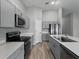 Bright kitchen features gray cabinetry, stainless steel appliances, and hard surface countertops at 12931 Twin Bridges Dr, Riverview, FL 33579