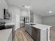 A modern kitchen with gray cabinets, stainless steel appliances, and a spacious center island at 12931 Twin Bridges Dr, Riverview, FL 33579