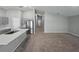 Open concept kitchen with stainless steel appliances, gray cabinets and large island at 12931 Twin Bridges Dr, Riverview, FL 33579