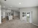 Open-concept living room flows to the kitchen and features sliding door access to outdoor space at 12931 Twin Bridges Dr, Riverview, FL 33579
