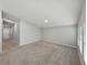 Bright and airy living room featuring neutral carpet and a view of a hallway at 12931 Twin Bridges Dr, Riverview, FL 33579