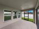 A covered patio with three windows and a screened door offers views of the backyard at 12931 Twin Bridges Dr, Riverview, FL 33579