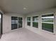 A covered patio features sliding glass doors and multiple windows for natural light at 12931 Twin Bridges Dr, Riverview, FL 33579