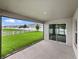 Covered patio overlooking a lush green lawn and white picket fence at 12931 Twin Bridges Dr, Riverview, FL 33579