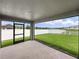 Covered patio area with views of the fenced backyard and lake at 12931 Twin Bridges Dr, Riverview, FL 33579
