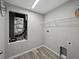 Utility room with laminate flooring, wire shelving, and AC system at 12931 Twin Bridges Dr, Riverview, FL 33579