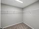 Large walk-in closet with carpeted floor and multiple wire rack shelves at 12931 Twin Bridges Dr, Riverview, FL 33579