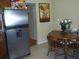 Eat-in kitchen features stainless steel refrigerator and table with seating at 1317 Tyrone N Blvd, St Petersburg, FL 33710