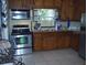 Functional kitchen with stainless steel appliances and wooden cabinetry at 1317 Tyrone N Blvd, St Petersburg, FL 33710