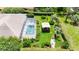 Aerial view showcasing the pool, covered gazebo, and beautiful landscaping at 14096 Pullman Dr, Spring Hill, FL 34609