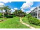 Serene backyard featuring a gazebo, screened lanai and stone paver walkway through a lush green lawn at 14096 Pullman Dr, Spring Hill, FL 34609