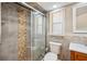 Bathroom features a glass-enclosed shower and a vanity with sink and framed mirror with small window at 14096 Pullman Dr, Spring Hill, FL 34609