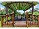 Charming gazebo with seating area offers a tranquil retreat amidst lush landscaping and greenery at 14096 Pullman Dr, Spring Hill, FL 34609