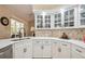 Bright kitchen featuring quartz countertops, white cabinets, and a modern faucet at 14096 Pullman Dr, Spring Hill, FL 34609