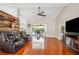 Expansive living area with hardwood floors, comfortable seating, and views to the patio at 14096 Pullman Dr, Spring Hill, FL 34609