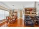 Open-concept living space featuring rich hardwood floors and an inviting leather recliner set at 14096 Pullman Dr, Spring Hill, FL 34609