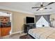 Bedroom featuring dark furniture, a ceiling fan, neutral walls, and backyard views at 14096 Pullman Dr, Spring Hill, FL 34609