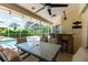 Inviting covered patio area with outdoor dining table, bar, and ceiling fan, perfect for entertaining at 14096 Pullman Dr, Spring Hill, FL 34609