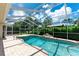 Inviting screened-in pool with patio and easy access to outdoor dining and green spaces at 14096 Pullman Dr, Spring Hill, FL 34609