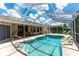 Spacious screened-in pool with easy access to outdoor dining and green spaces at 14096 Pullman Dr, Spring Hill, FL 34609