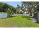 A spacious back yard with green grass and a white fence create a private outdoor oasis at 1513 Loretta Ct, Brandon, FL 33511