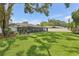 Expansive backyard with lush green grass and screened-in porch is perfect for outdoor living at 1513 Loretta Ct, Brandon, FL 33511